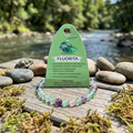Pulsera de fluorita natural 6 mm con tarjeta “Fluorita” y río al fondo | AuryStone